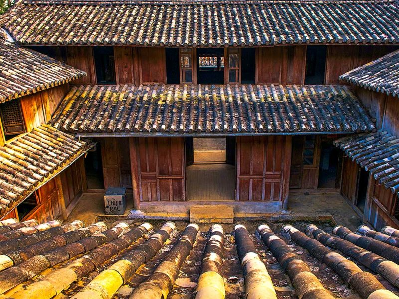 Oud houten dak en binnenhof van het Hmong King Palace in Dong Van, Ha Giang.